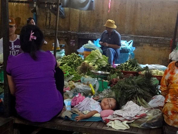 A little child sleeping in another, smaller market in Phnom Penh.