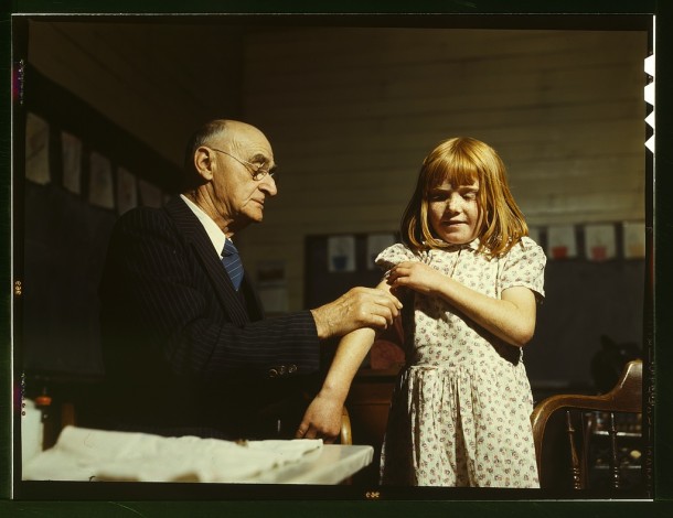 Dr. Schreiber of San Augustine giving a typhoid inoculation at a rural school, San Augustine County, Texas, 1943. Photographer: John Vachon